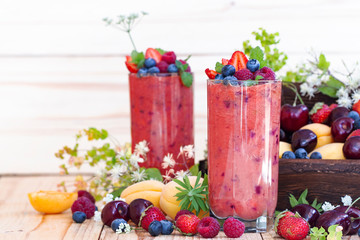 sweet healthy dessert with fresh fruits and berries. smoothies with blueberries, strawberries, apricots. Summer berry milkshake. The yogurt drink, a vitamin cocktail. Vegetarian nutrition.
