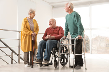 Group of happy senior people in hospital