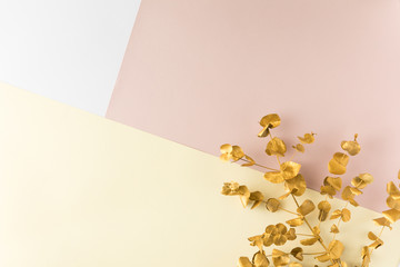 Golden tropical palm leaf on pink background. Flat lay, top view. Minimal beauty fashion concept.