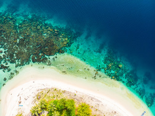 Aerial top down tropical archipelago Indonesia, coral reef white sand beach beach turquoise water. Travel destination, uncontaminated ecosystem