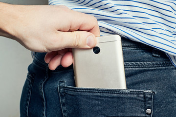 Thief steal smartphone from a back pocket jeans