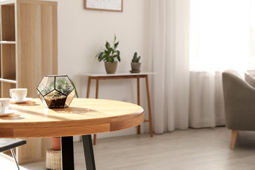 Succulents in florarium on table indoors, space for text. Trendy home interior with plants
