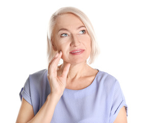 Portrait of charming mature woman with healthy beautiful face skin and natural makeup on white background