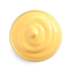 Delicious cheese sauce in bowl on white background, top view