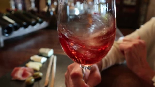 Wine test, crystal glass, red wine, cheese, bar counter background. Glasses of wine and cheese plate. Wine testing.