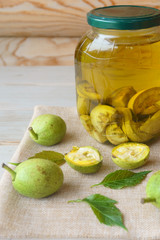 green walnut in a glass jar filled with alcohol, tincture for treatment.