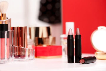 Different lipsticks on dressing table. Space for text