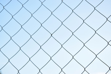  Iron mesh against a blue sky.