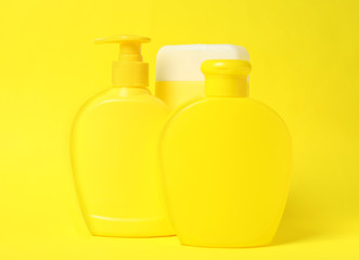 Bottles of shampoo on yellow background. Natural cosmetic products