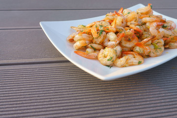 fried shrimps on a white plate with herbs