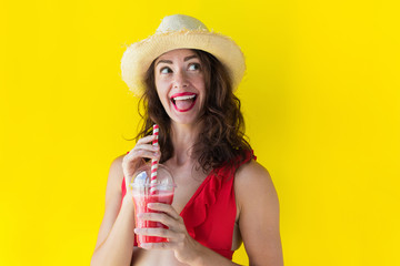 Happy young brunette woman drinks fruit juice