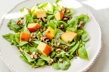 Purslane Salad with Peach Fruit, Roasted Walnuts and Pine Nuts.