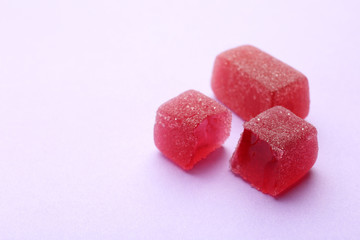 Tasty jelly candies on color background, space for text