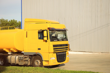 Fototapeta na wymiar Modern yellow truck on country road. Space for text