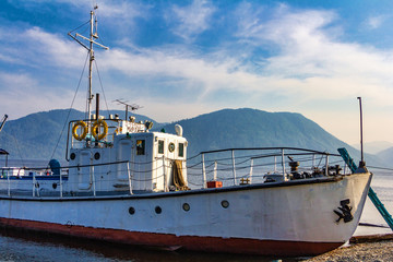 old ship moored on seashore at sunny day 