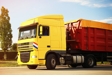 Fototapeta na wymiar Modern bright truck parked on country road