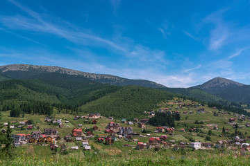 Fototapeta na wymiar Beautiful summer landscape wint mountains. Carpatian village at mountains