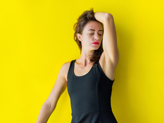 Young woman black gress is posing smiling coquetting