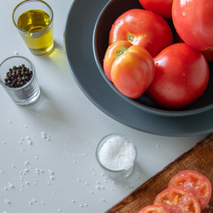 Cooking tomatoes, preparing fresh salad. Vegetarian diet