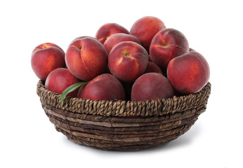 Basket of delicious ripe peaches isolated on white