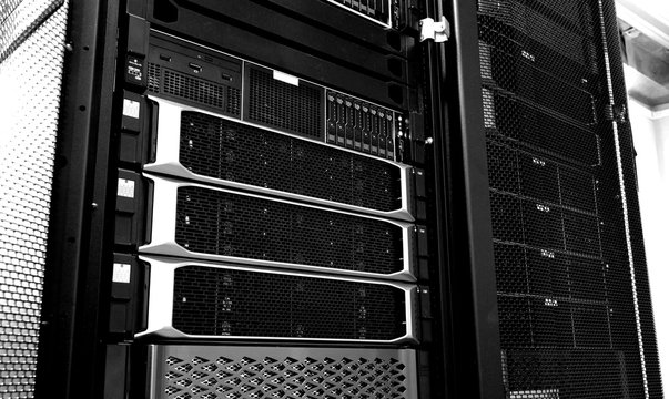 Blade server in rack cluster hard drives storage in internet data center room black and white tone