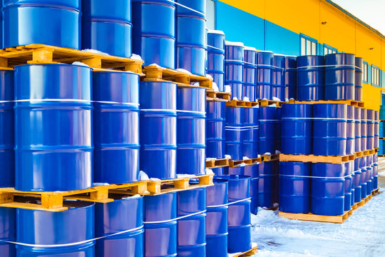 Plastic containers palletized near the stock. Barrels for toxic substances. Chemical storage tanks. Barrels for shipment from stock. Transport of hazardous liquids. Warehouse work. Chemical industry.