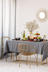 Dining room design idea with stylish chair and table with grey tablecloth