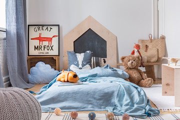 Blue boy's bedroom with toys and wooden furniture, real photo with mockup