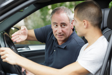 two men discussing work in a car