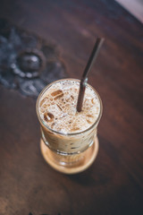 ice coffee in glass on wooden table
