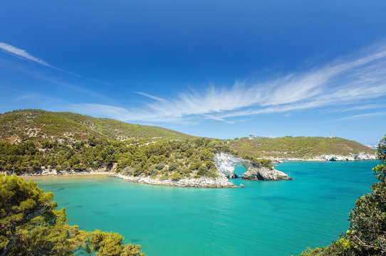 Italian touristic destination in Puglia - San Felice arch rock bay - Natural park Gargano with beautifulturquoise sea. Apulia, Southern Italy, Europe