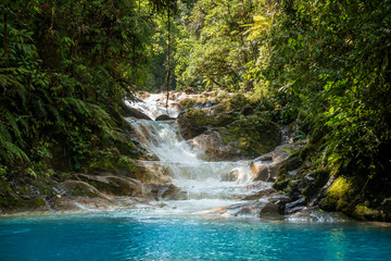 Blue falls of Costa Rica, natural landscape at Bajos del Toro close to the Catarata del Toro and San Jose. Photo taken at slow shutter speed and with ND filter. Smooth waterfall. 