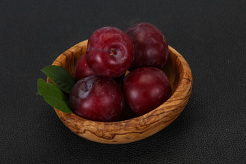 Plum heap in the wooden basket