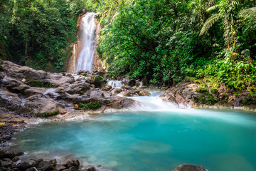 Blue falls of Costa Rica, natural landscape at Bajos del Toro close to the Catarata del Toro and San Jose. Photo taken at slow shutter speed and with ND filter. Smooth waterfall. 