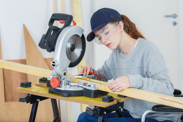 girl in wheelchair works great circular saw