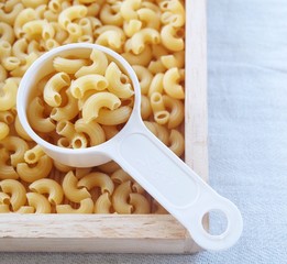 Dried Elbow Macaroni in A Measuring Cup