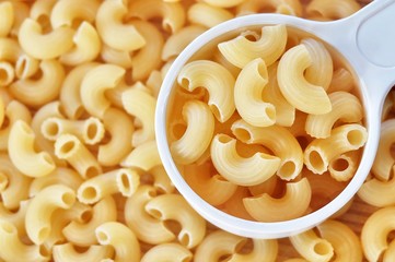 Dried Elbow Macaroni in A Measuring Cup