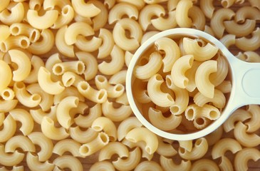Dried Elbow Macaroni in A Measuring Cup