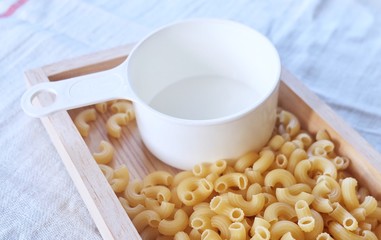 Dried Elbow Macaroni with A Measuring Cup