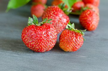 Fresh ripe red strawberries on gray table. Diet, healthy, vegan.