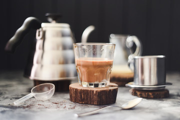 Vietnamese pour over coffee with condensed milk maked in phin on dark background