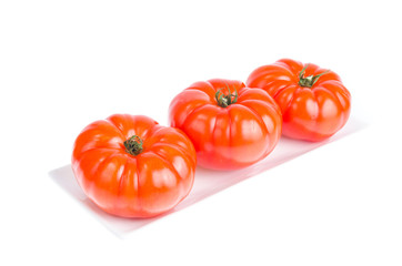 Three red ripe tomato beef. Studio Photo