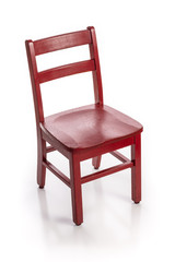 Wooden child chair painted red isolated on a white background.
