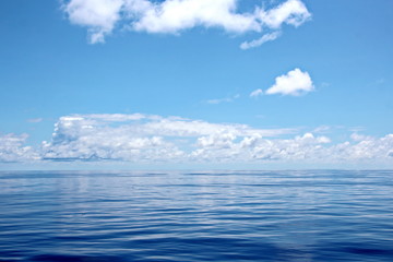 Blue sky and clouds in the open ocean. Views of the ship's mast and antennas on the navigation deck.