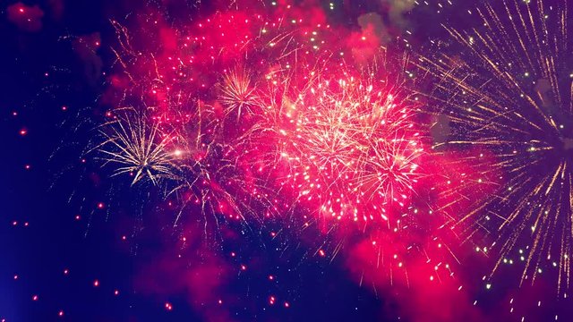 Colourful flashes of fireworks are bursting in the sky