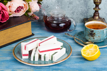 Composition on table with marshmallows, cup of tea.