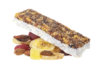 Granola bar on heap of dried fruits, seeds and nuts. White background. Concept of healthy food.