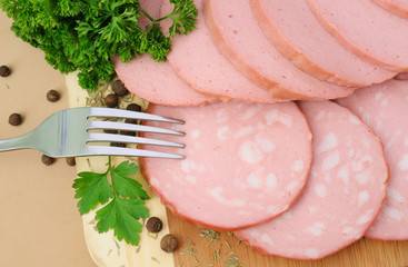 Slices of sausage with greenery and seasonings