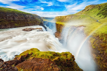 Iceland, Gullfoss waterfall. Captivating scene with rainbow of Gullfoss waterfall that is most powerful waterfall in Iceland and Europe. Picturesque summer scene with amazing Icelandic waterfall. - obrazy, fototapety, plakaty