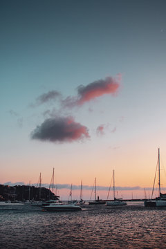 Lovely romantic harbor view with sailing boats and colorful sunset light and clouds. Evening walk alongside the port with coean view. Port d' Andratx, Port Andratx, Mallorca Spain Balearics